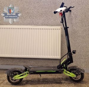Hulajnoga elektryczna, na której doszło do zdarzenia. W lewym górnym rogu znajduje się logo Komendy Powiatowej Policji w Pabianicach.