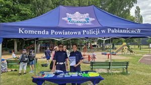 Policjantki stoją pod policyjnym namiotem.