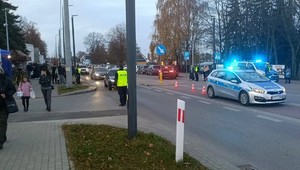 Policjant czuwający nad bezpieczeństwem osób przemieszcających się w obrębie cmentarza.