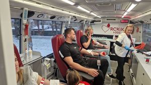 Osoby oddające krew w krwiobusie.